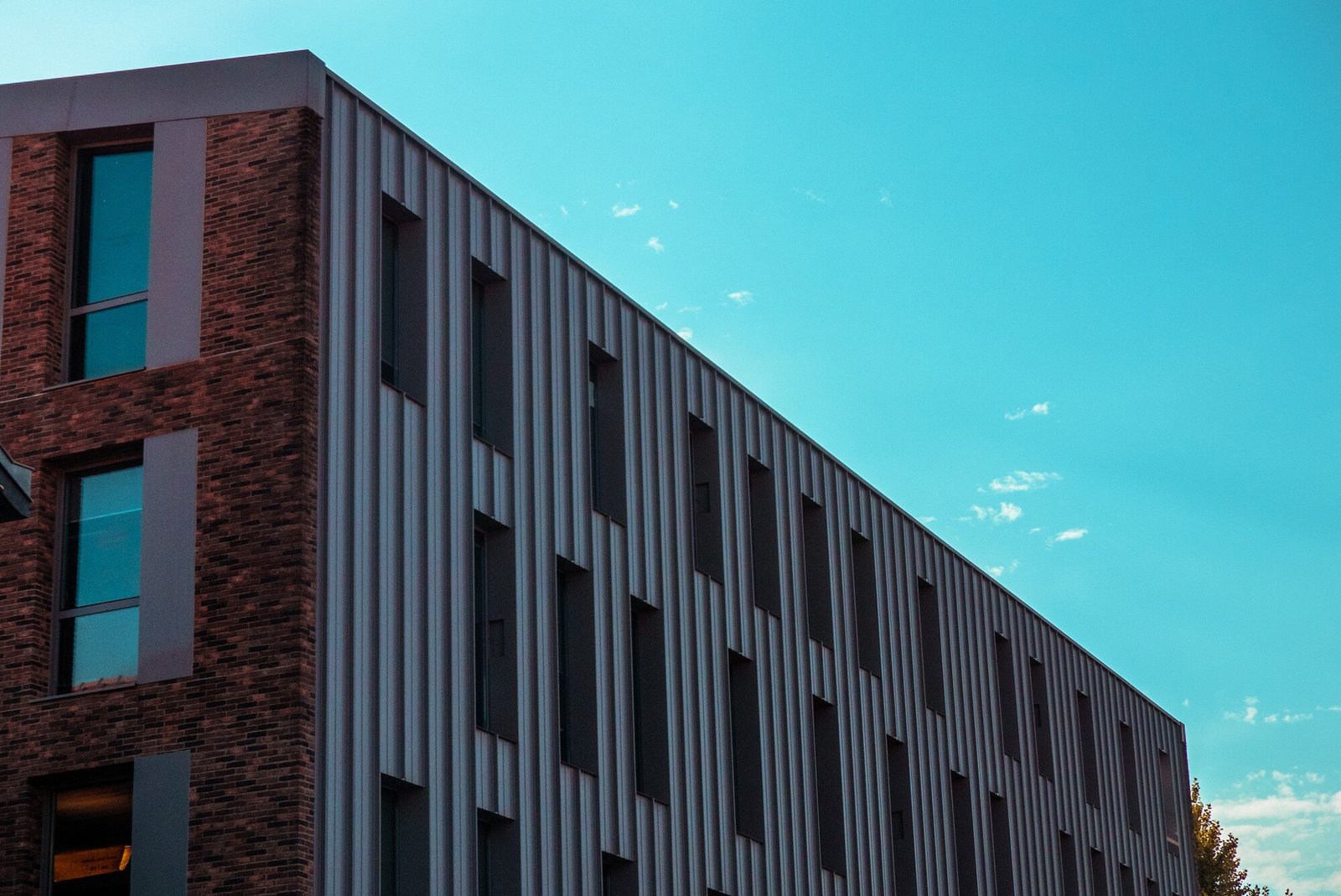 Modern UK commercial building with sprayed vertical metal cladding