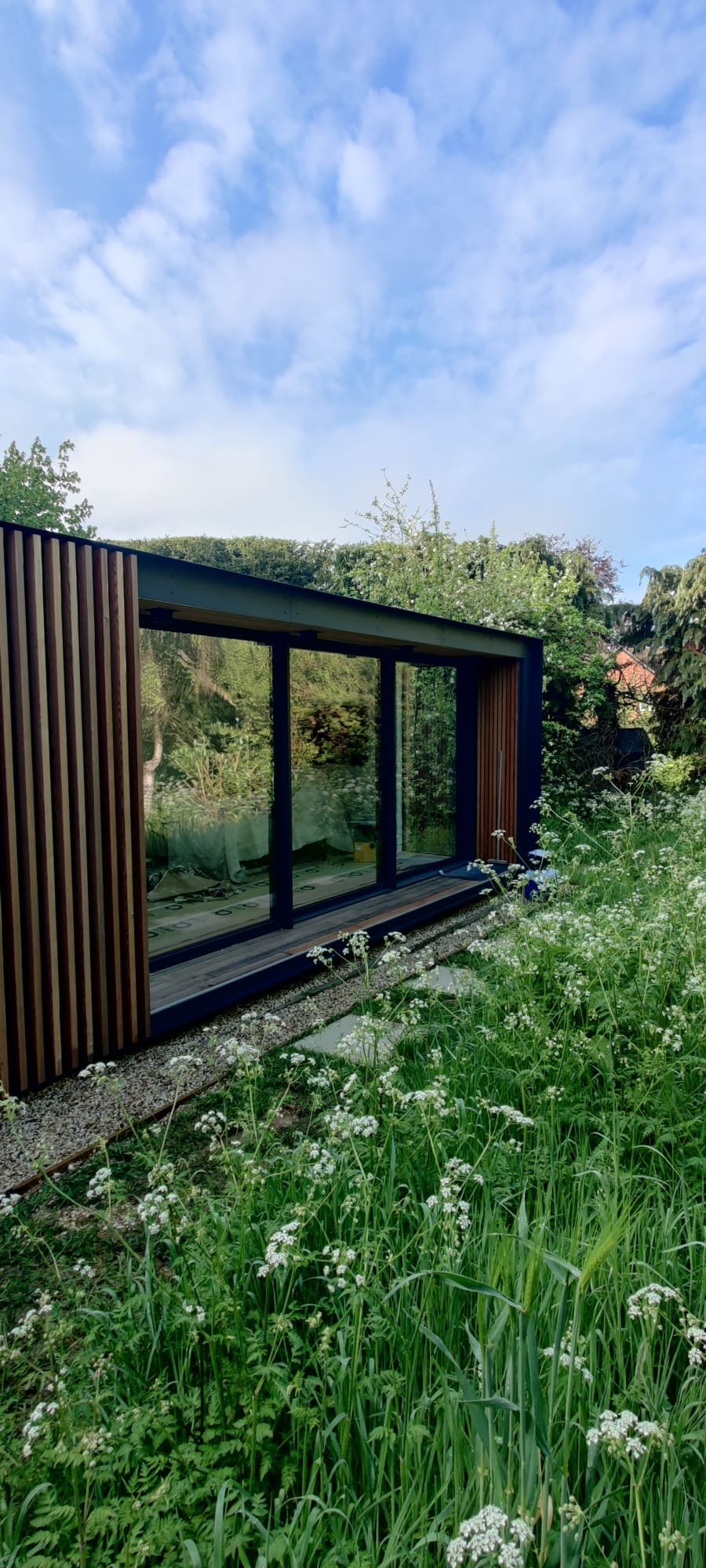 Exterior UPVC window frames and cladding sprayed in anthracite on a garden building